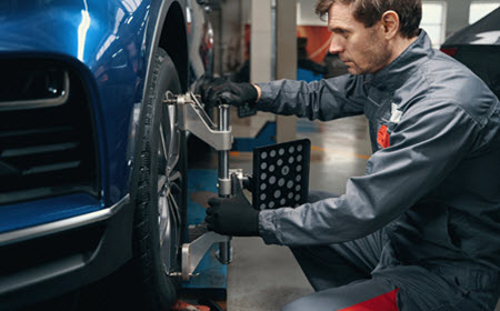 Audi Mechanic Checking Wheel Alignment